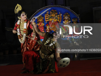 Dancers perform the ''Durgotsab'' dance dressed as goddess Durga and a demon ahead of the Durga Puja festival inside the historic Victoria M...