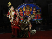 Dancers perform the ''Durgotsab'' dance dressed as goddess Durga and a demon ahead of the Durga Puja festival inside the historic Victoria M...