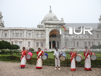 Drummers play their traditional Indian drums called ''Dhak'' in front of the historic Victoria Memorial monument, built during British colon...