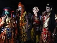 Performers dress as Hindu gods, and a performer dressed as goddess Durga drinks tea at a tea stall in Kolkata, India, on October 4, 2024. Th...