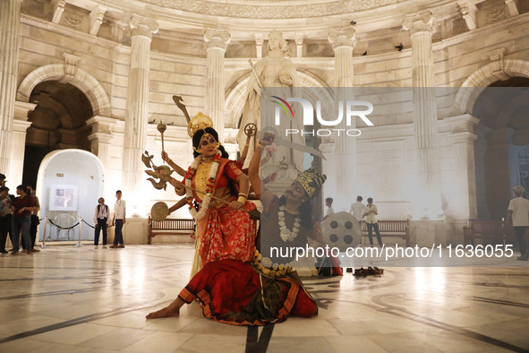 Dancers perform the ''Durgotsab'' dance dressed as goddess Durga and a demon ahead of the Durga Puja festival inside the historic Victoria M...