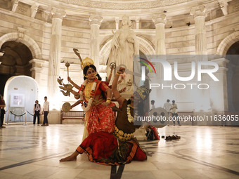 Dancers perform the ''Durgotsab'' dance dressed as goddess Durga and a demon ahead of the Durga Puja festival inside the historic Victoria M...