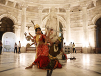 Dancers perform the ''Durgotsab'' dance dressed as goddess Durga and a demon ahead of the Durga Puja festival inside the historic Victoria M...