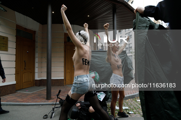 (EDITORS NOTE: Image contains nudity and profanity.)  Barechested Femen activists, with slogans written on their bodies, protest against Teh...