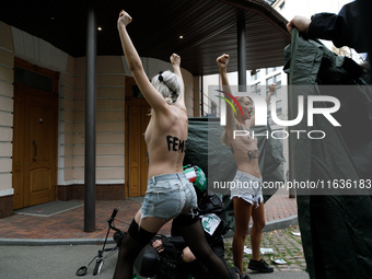 (EDITORS NOTE: Image contains nudity and profanity.)  Barechested Femen activists, with slogans written on their bodies, protest against Teh...