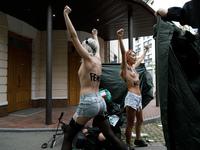 (EDITORS NOTE: Image contains nudity and profanity.)  Barechested Femen activists, with slogans written on their bodies, protest against Teh...