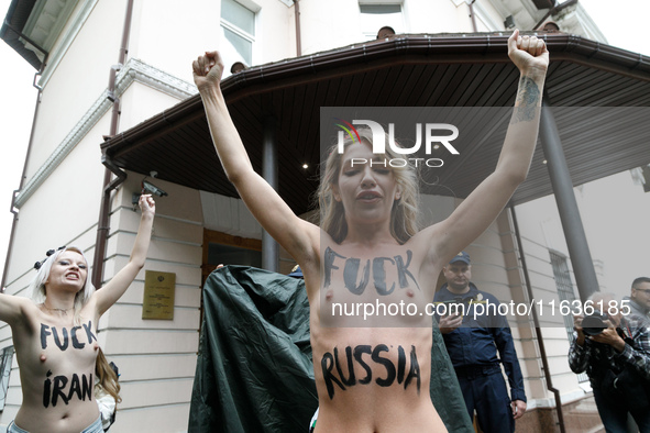 (EDITORS NOTE: Image contains nudity and profanity.) Barechested Femen activists, with slogans written on their bodies, protest against Tehr...