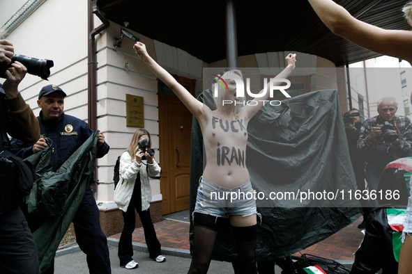 (EDITORS NOTE: Image contains nudity and profanity.) A barechested Femen activist, with a slogan marked on her body, protests against Tehran...