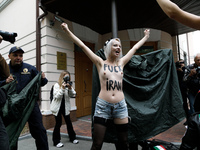 (EDITORS NOTE: Image contains nudity and profanity.) A barechested Femen activist, with a slogan marked on her body, protests against Tehran...