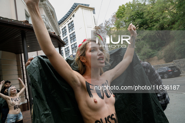 (EDITORS NOTE: Image contains nudity and profanity.) A barechested Femen activist, with a slogan marked on her body, protests against Tehran...