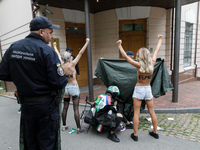 Barechested Femen activists, with the name of the movement marker written on their backs, protest against Tehran's military support of Russi...