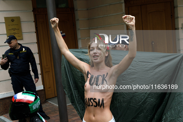 (EDITORS NOTE: Image contains nudity and profanity.) A barechested Femen activist, with a slogan marked on her body, protests against Tehran...