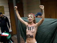 (EDITORS NOTE: Image contains nudity and profanity.) A barechested Femen activist, with a slogan marked on her body, protests against Tehran...