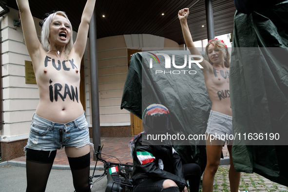 (EDITORS NOTE: Image contains nudity and profanity.) Barechested Femen activists, with slogans written on their bodies, protest against Tehr...