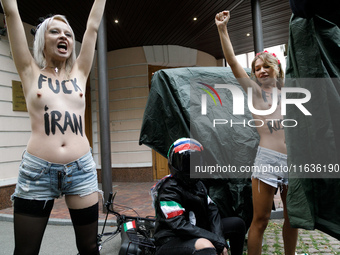 (EDITORS NOTE: Image contains nudity and profanity.) Barechested Femen activists, with slogans written on their bodies, protest against Tehr...