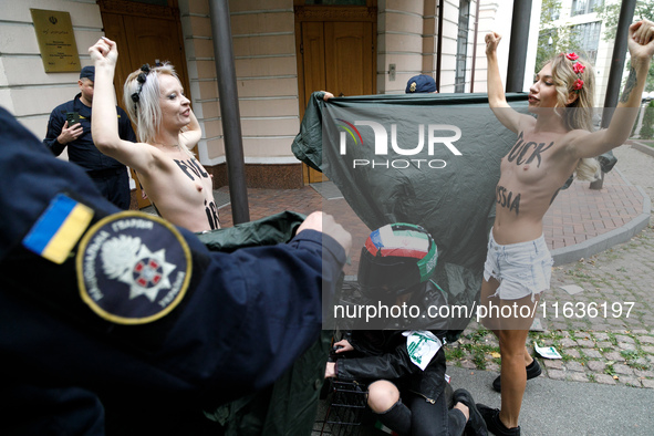 (EDITORS NOTE: Image contains nudity and profanity.) Barechested Femen activists, with slogans written on their bodies, protest against Tehr...