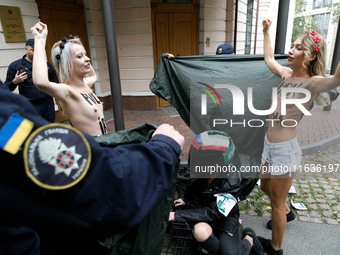 (EDITORS NOTE: Image contains nudity and profanity.) Barechested Femen activists, with slogans written on their bodies, protest against Tehr...