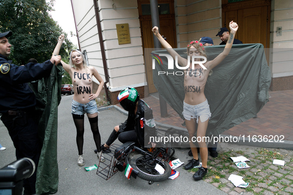 (EDITORS NOTE: Image contains nudity and profanity.) Barechested Femen activists, with slogans written on their bodies, protest against Tehr...