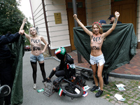 (EDITORS NOTE: Image contains nudity and profanity.) Barechested Femen activists, with slogans written on their bodies, protest against Tehr...