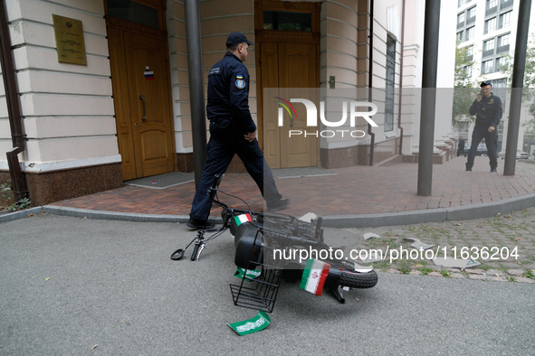 A moped with stickers in the form of the flag of the Islamic Republic of Iran, on which one of the activists of the Femen movement arrives a...