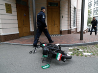 A moped with stickers in the form of the flag of the Islamic Republic of Iran, on which one of the activists of the Femen movement arrives a...