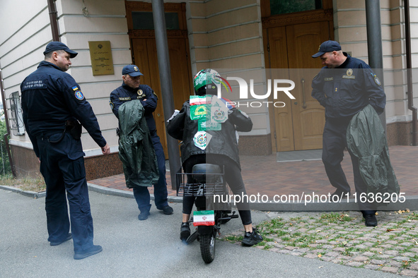 A Femen activist sits on a moped outside the Embassy of Iran to participate in a protest against Tehran's military support of Russia in Kyiv...