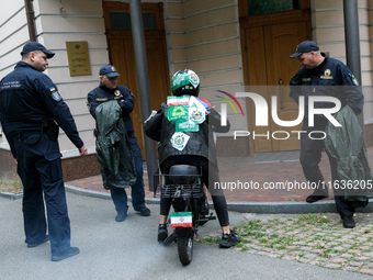 A Femen activist sits on a moped outside the Embassy of Iran to participate in a protest against Tehran's military support of Russia in Kyiv...