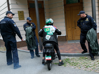 A Femen activist sits on a moped outside the Embassy of Iran to participate in a protest against Tehran's military support of Russia in Kyiv...