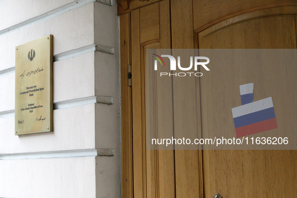 Stickers with the Russian tricolor flag are pasted on the doors of the Iranian Embassy by Femen activists during a protest action against Te...