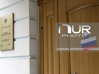 Stickers with the Russian tricolor flag are pasted on the doors of the Iranian Embassy by Femen activists during a protest action against Te...