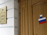 Stickers with the Russian tricolor flag are pasted on the doors of the Iranian Embassy by Femen activists during a protest action against Te...