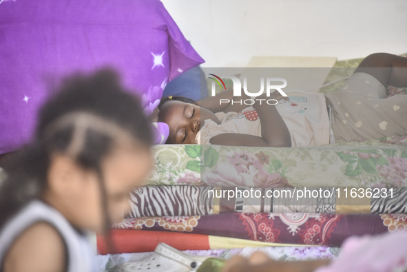 Migrant workers arrive at the Saint Joseph Jesuites Fathers Church, which is turned into a shelter to house families fleeing their homes as...