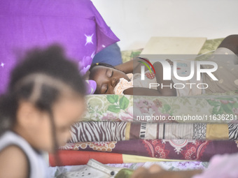 Migrant workers arrive at the Saint Joseph Jesuites Fathers Church, which is turned into a shelter to house families fleeing their homes as...