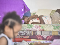 Migrant workers arrive at the Saint Joseph Jesuites Fathers Church, which is turned into a shelter to house families fleeing their homes as...