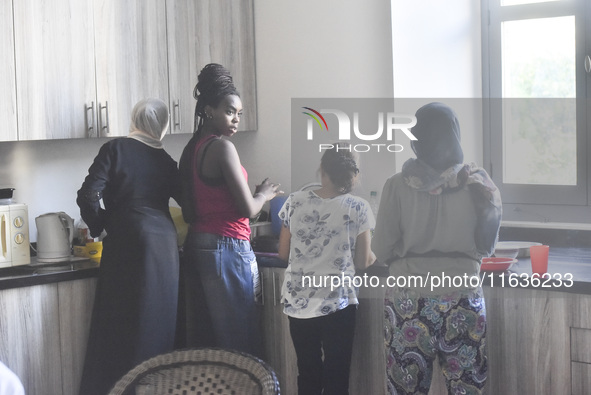 Migrant workers arrive at the Saint Joseph Jesuites Fathers Church, which is turned into a shelter to house families fleeing their homes as...