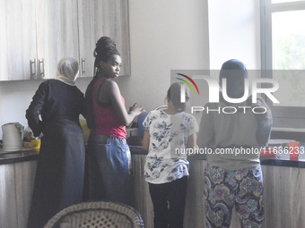 Migrant workers arrive at the Saint Joseph Jesuites Fathers Church, which is turned into a shelter to house families fleeing their homes as...