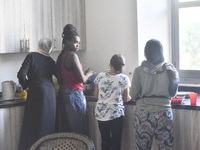 Migrant workers arrive at the Saint Joseph Jesuites Fathers Church, which is turned into a shelter to house families fleeing their homes as...