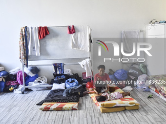 Migrant workers arrive at the Saint Joseph Jesuites Fathers Church, which is turned into a shelter to house families fleeing their homes as...