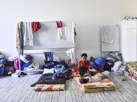 Migrant workers arrive at the Saint Joseph Jesuites Fathers Church, which is turned into a shelter to house families fleeing their homes as...