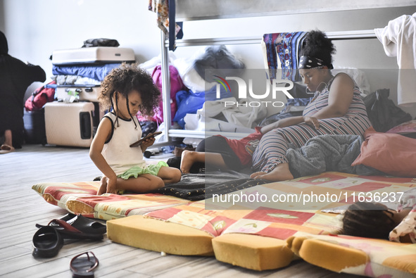 Migrant workers arrive at the Saint Joseph Jesuites Fathers Church, which is turned into a shelter to house families fleeing their homes as...