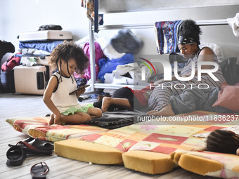 Migrant workers arrive at the Saint Joseph Jesuites Fathers Church, which is turned into a shelter to house families fleeing their homes as...