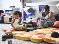 Migrant workers arrive at the Saint Joseph Jesuites Fathers Church, which is turned into a shelter to house families fleeing their homes as...