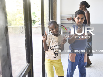 Migrant workers arrive at the Saint Joseph Jesuites Fathers Church, which is turned into a shelter to house families fleeing their homes as...