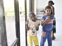 Migrant workers arrive at the Saint Joseph Jesuites Fathers Church, which is turned into a shelter to house families fleeing their homes as...