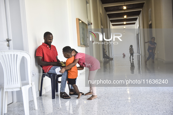 Migrant workers arrive at the Saint Joseph Jesuites Fathers Church, which is turned into a shelter to house families fleeing their homes as...