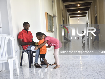 Migrant workers arrive at the Saint Joseph Jesuites Fathers Church, which is turned into a shelter to house families fleeing their homes as...