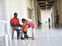 Migrant workers arrive at the Saint Joseph Jesuites Fathers Church, which is turned into a shelter to house families fleeing their homes as...