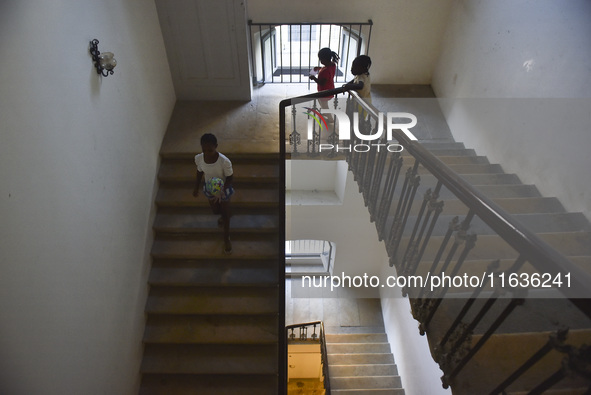 Migrant workers arrive at the Saint Joseph Jesuites Fathers Church, which is turned into a shelter to house families fleeing their homes as...