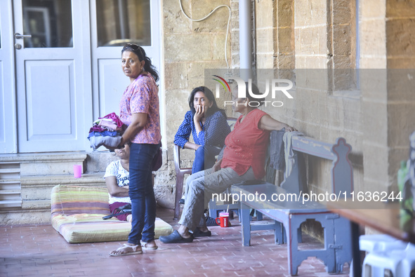 Migrant workers arrive at the Saint Joseph Jesuites Fathers Church, which is turned into a shelter to house families fleeing their homes as...