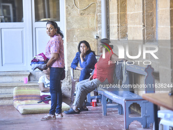 Migrant workers arrive at the Saint Joseph Jesuites Fathers Church, which is turned into a shelter to house families fleeing their homes as...